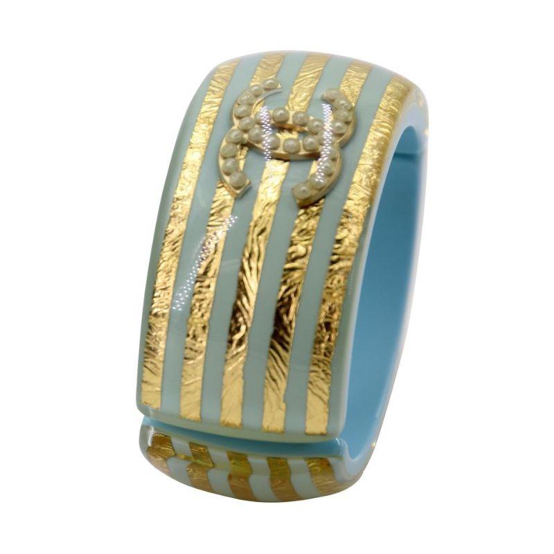 Chanel Cc Monogram Cuff Mother Of Pearl Resin Bracelet CC-0829N-0006

Chanel rare limited edition resin turquoise blue bracelet with amazing mother of pearl details CC logo with original gold design. This model is completely sold out everywhere and
