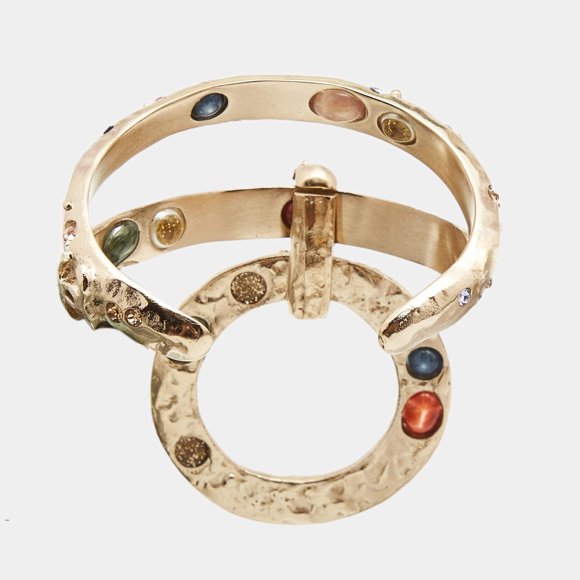 A chic statement piece from the luxury brand, Chanel, the multi-coloured Crystals Bracelet comes with gold tone hardware. The bracelet has the CC logo engraved on it and is decorated with appealing embellishments. This bracelet is beautiful to wear