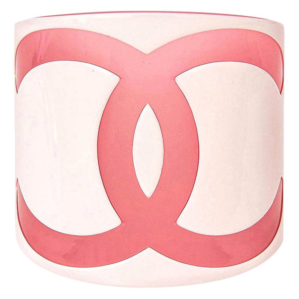 This ultra chic pink and white plastic resort Chanel CC cuff bracelet is wide on the wrist and fits a small wrist like a size 6 to 6.5 perhaps seven 7