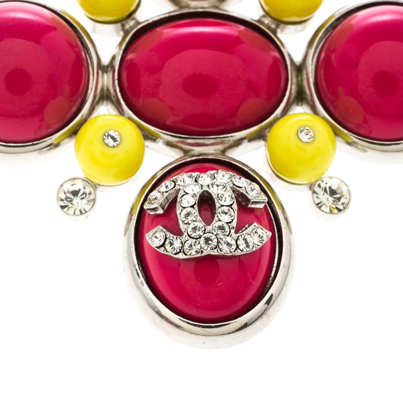 One can't help but fall in love with this stunning brooch from Chanel. The piece is chic and modern in its looks with pink cabochons, yellow beads and crystals. A crystal embellished CC logo sits proudly on one of the cabochons. It is completed with