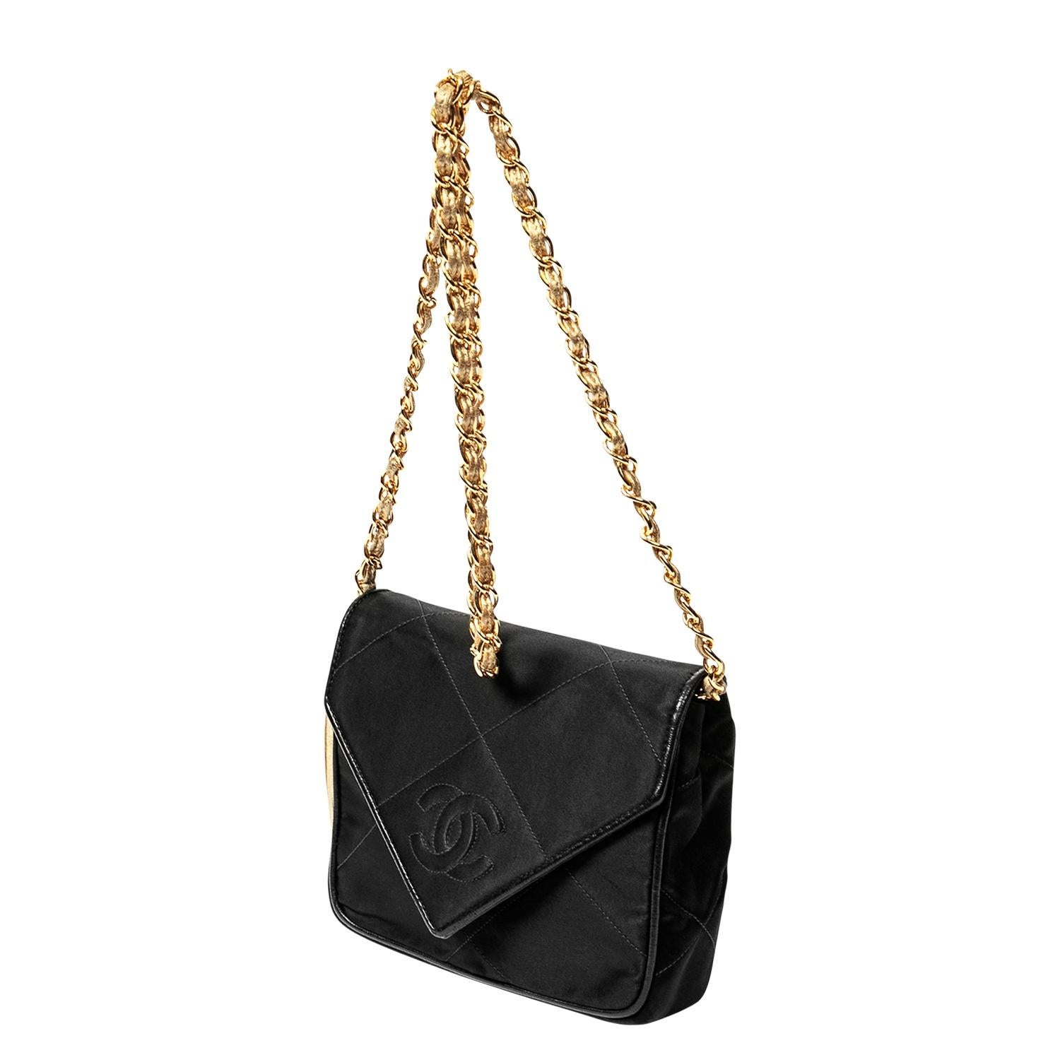 Wedding season is upon us!! This is the perfect elegant vintage Chanel envelope CC Flap Bag. The black/gold combo is spirited and sharp and can definitely be dressed down too, paired with denim and a slingback heel. Crafted in black satin, a subtle