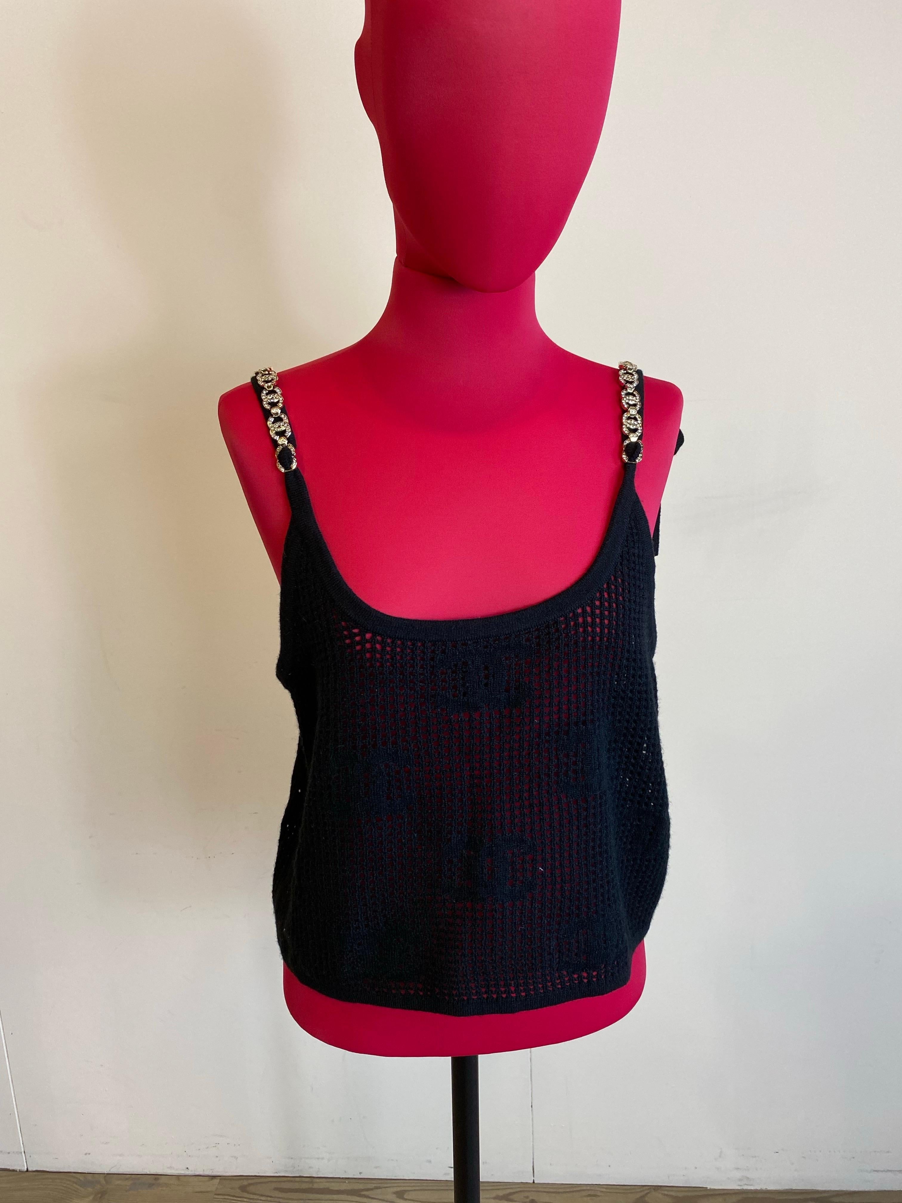 Chanel top. 
Missing composition label. We think it is a cashmere and wool blend. 
Featuring CC metal strass on shoulder straps. 
Missing composition label but fits an international M. Bust 47 cm Length 53 cm 
Good overall condition, shows minimal