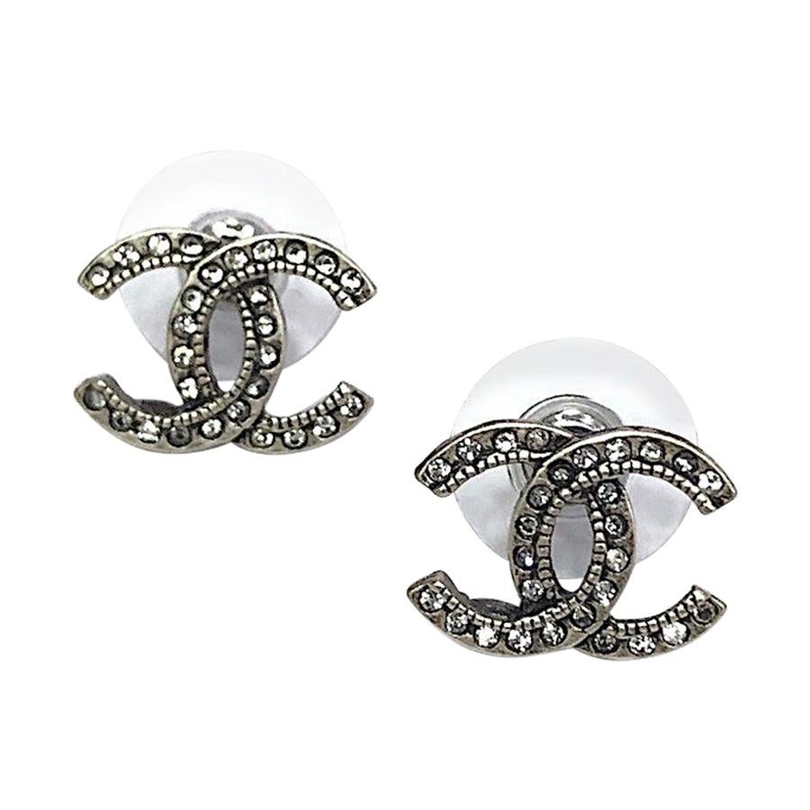 CHANEL CC Stud Earrings in Aged Silver Metal and Rhinestones at