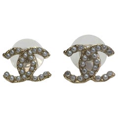 CHANEL CC Stud Earrings  in Gilt Metal set with Pearl Beads.