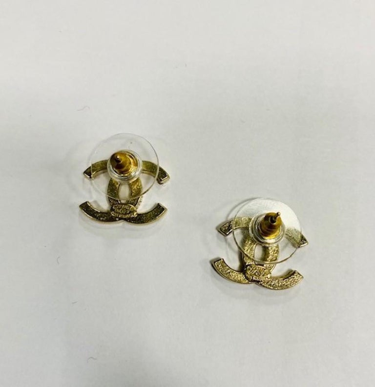 CHANEL CC Stud Earrings in Pale Gilded Metal