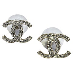 CHANEL CC Stud Earrings in Pale Gilded Metal