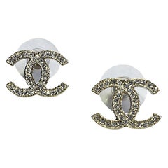 CHANEL CC Stud Earrings in Pale Gilded Metal