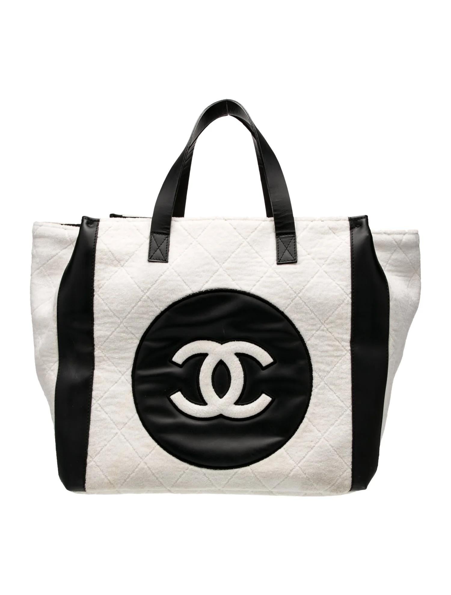 This Chanel tote bag is constructed of black and white terry cloth with an interlocking CC logo on the front. It features silver-tone hardware, dual flat handles, a canvas-lined interior, and an open-top design.

Color: black and white
Material: