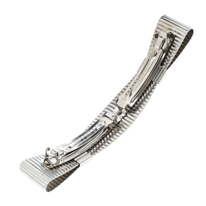 How sweet and pretty is this barrette from Chanel! It has been beautifully made in France from textured silver-tone metal and designed as a bow with the CC logo. You can clip it to your hair using the double clasps at the back.

Includes: Original