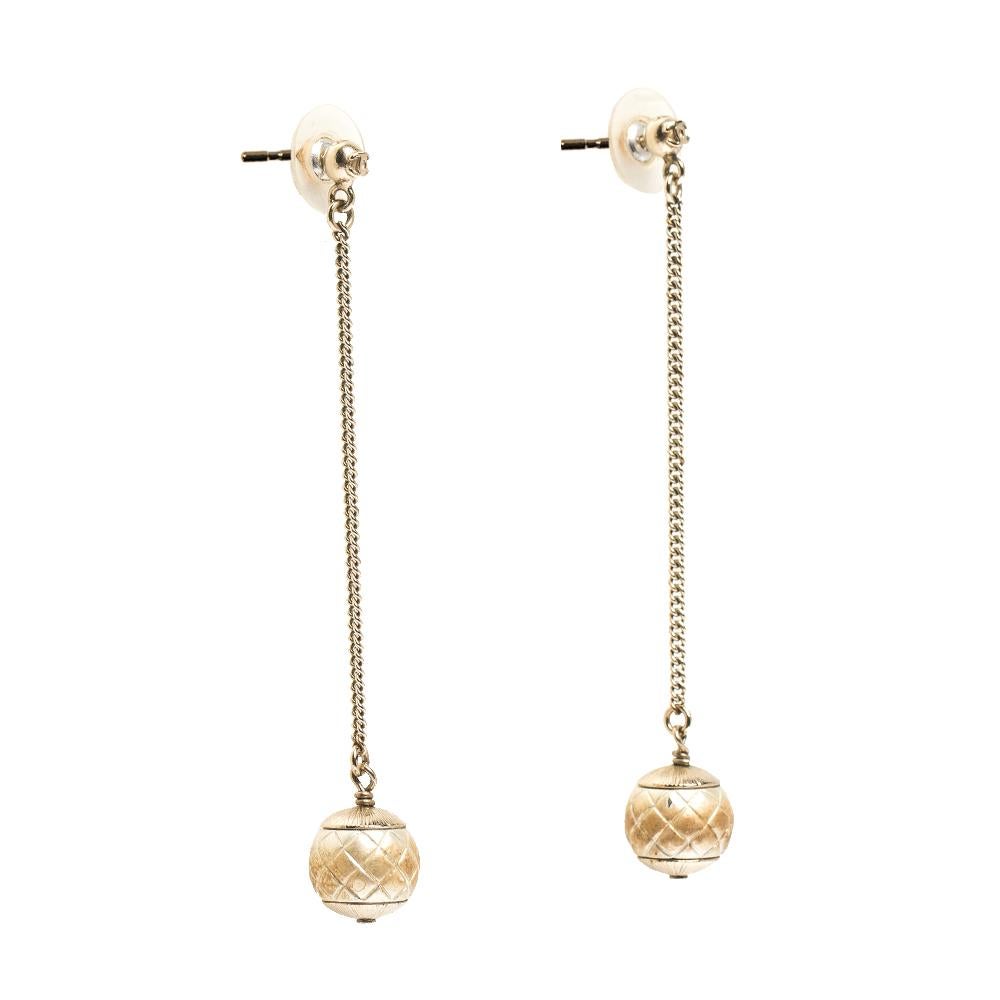 Beautiful and feminine, these earrings from Chanel are rendered in gold-tone metal. The pair catches your attention with its long shape that ends with textured faux pearl drops. Complete with push back fastenings, this pair will make a luxurious