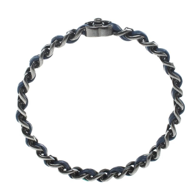 This Chanel piece is a beauty to behold. It has been crafted out of silver-tone metal and styled in a single strand of navy blue leather woven chain. It also features the signature CC logo carrying a turnlock. This bangle bracelet is classy and will