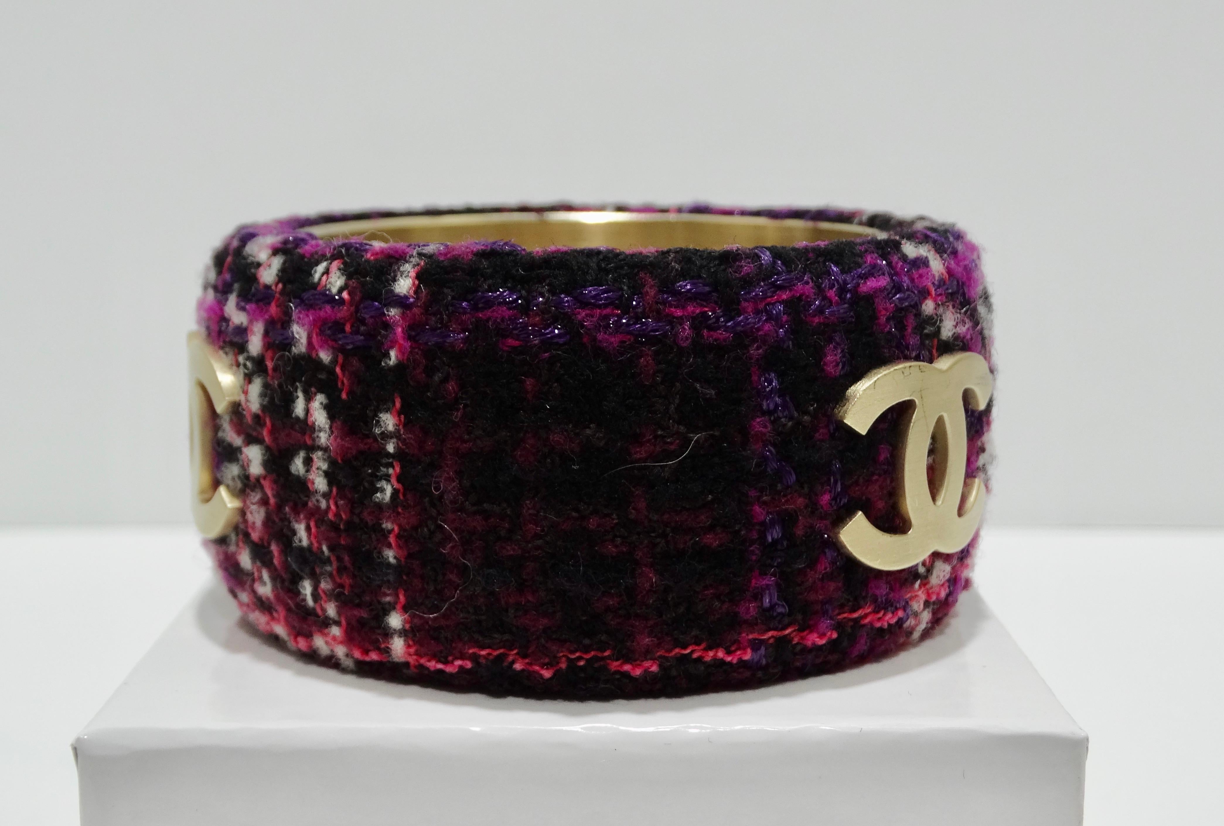Calling all Chanel lovers! Circa 2009 from their fall/winter collection, this cuff features pink, purple, black and white tweed with brushed gold hardware. Spaced evenly throughout the cuff is the iconic CC logo. Interior stamp reads 09A made in