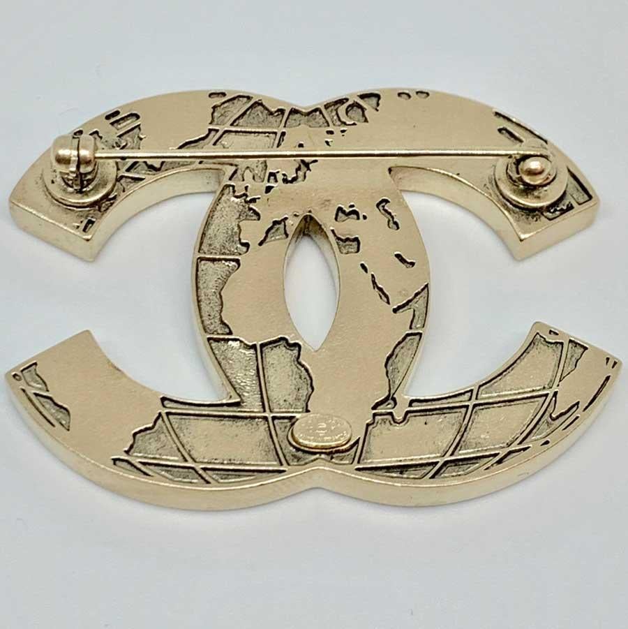 Very beautiful CC brooch from Maison CHANEL representing a world map. It is made of pale gold metal and beige resin. The back represents the world in relief.
This brooch comes from the 2013 collection. Made in France.
It is in very good condition.