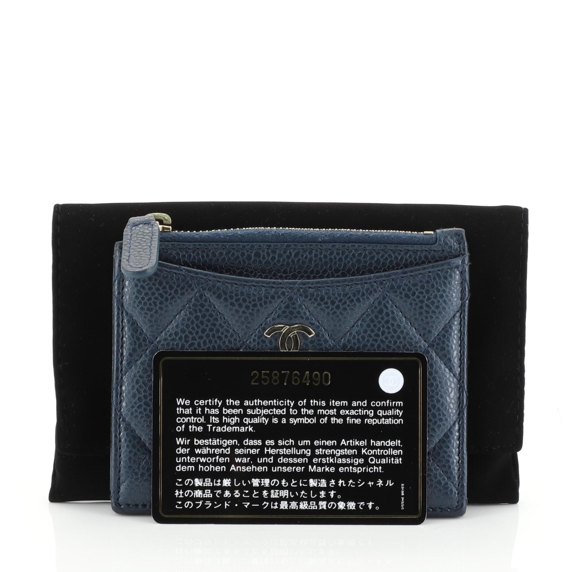This Chanel CC Zip Card Holder Quilted Caviar, crafted from blue quilted caviar leather, features exterior slip pockets, CC logo and gold-tone hardware. Its zip closure opens to a blue fabric interior. Hologram sticker reads: 25876490. 

Estimated
