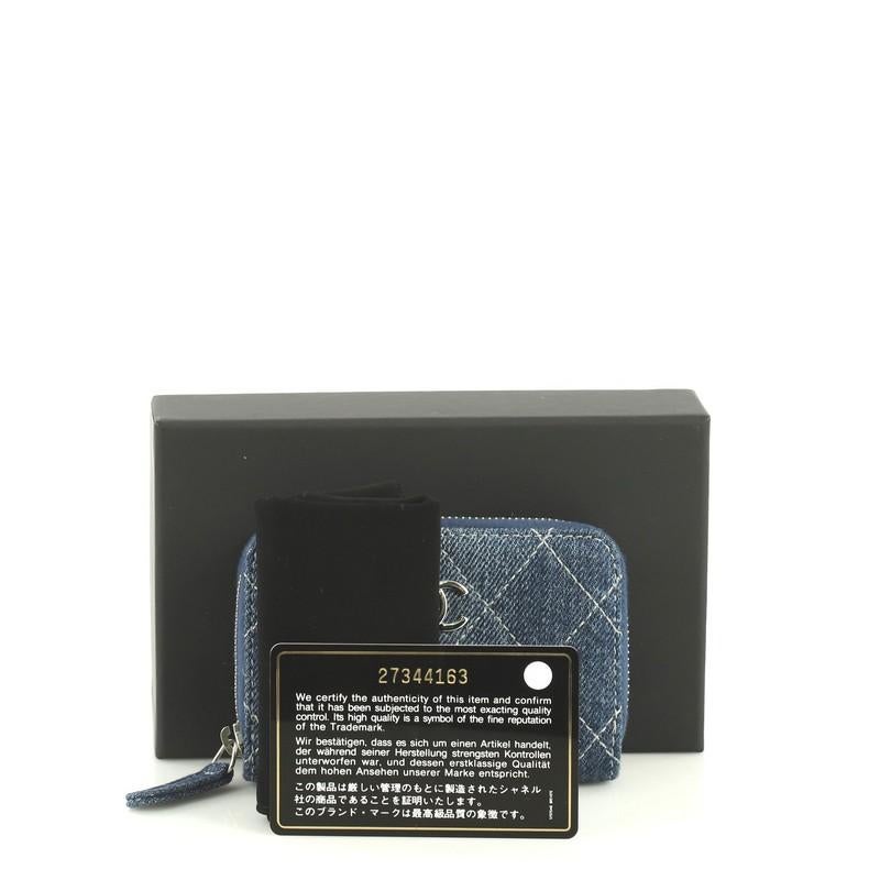 This Chanel CC Zip Coin Purse Quilted Denim Small, crafted from blue quilted denim, features CC logo and silver-tone hardware. Its all-around zip closure opens to a blue denim interior divided into three compartments. Hologram sticker reads: