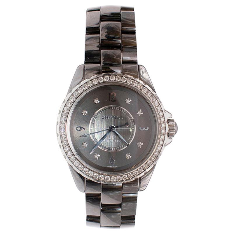 Chanel Ceramic Grey J12 Diamond 38mm Watch

- 38mm Ceramic case
- Grey dial
- Sapphire crystal glass
- Automatic movement
- Diamond set dial (8 diamonds) 
- 54 diamond bezel 1.4 Carat
- Folding clasp
- Water resistant to 50m 
 
Diameter 3.8cm
Fits