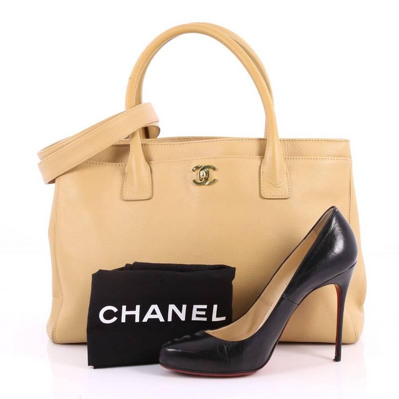 This authentic Chanel Cerf Executive Tote Leather Medium is an ideal everyday accessory for the modern woman. Crafted in tan leather, this classic and functional tote features a CC turn-lock closure that opens the exterior front pocket, back pocket,