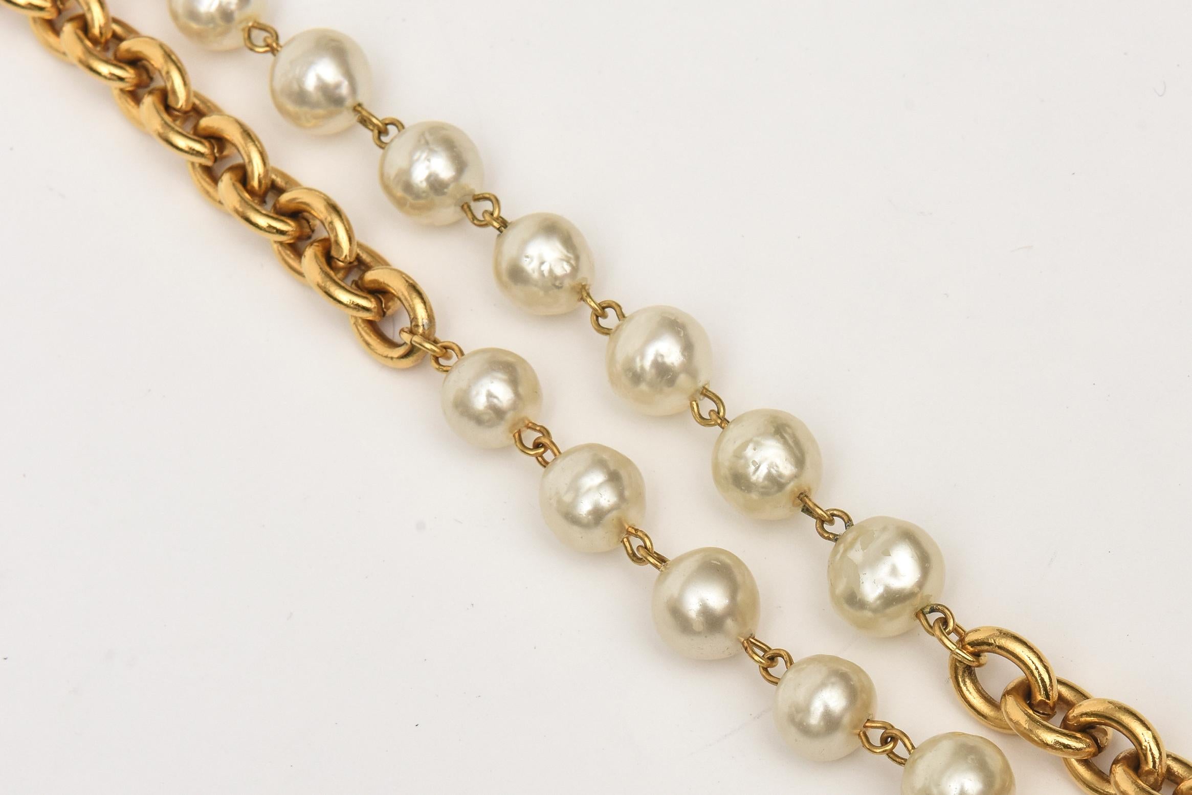 This classic Chanel double strand is oval link chain with interspersed faux Chanel pearls. The circa is 1990. It is very long and can be doubled up or tripled up. Very chic and always in style and season. This is again classic Chanel. Sometimes