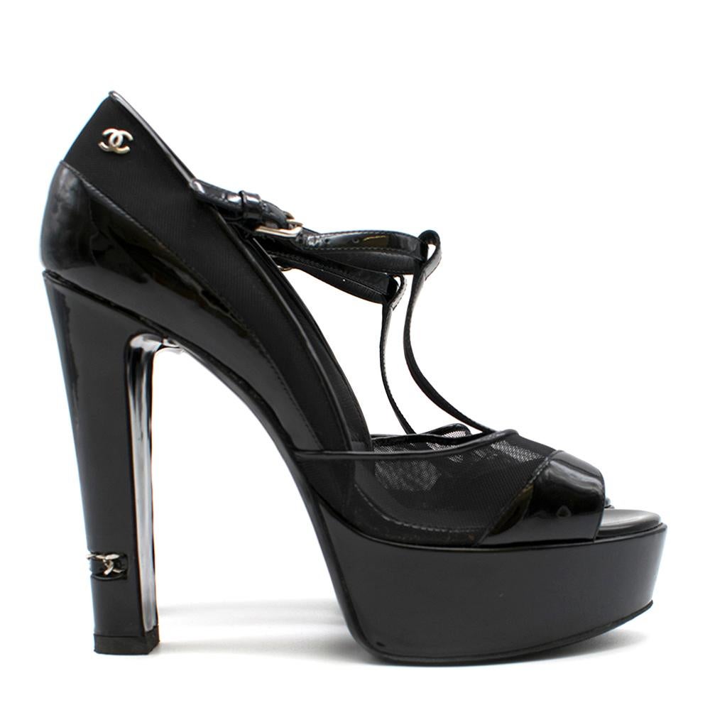 Chanel Open Toe Patent Leather Platform Heels

Platform heels
Cut out design 
Ankle strap with buckle closure
Netted detailing
Patent black leather 
Open toe 
Chain detailing on heel
Black leather insole with silver 'Chanel' and logo 
Black sole