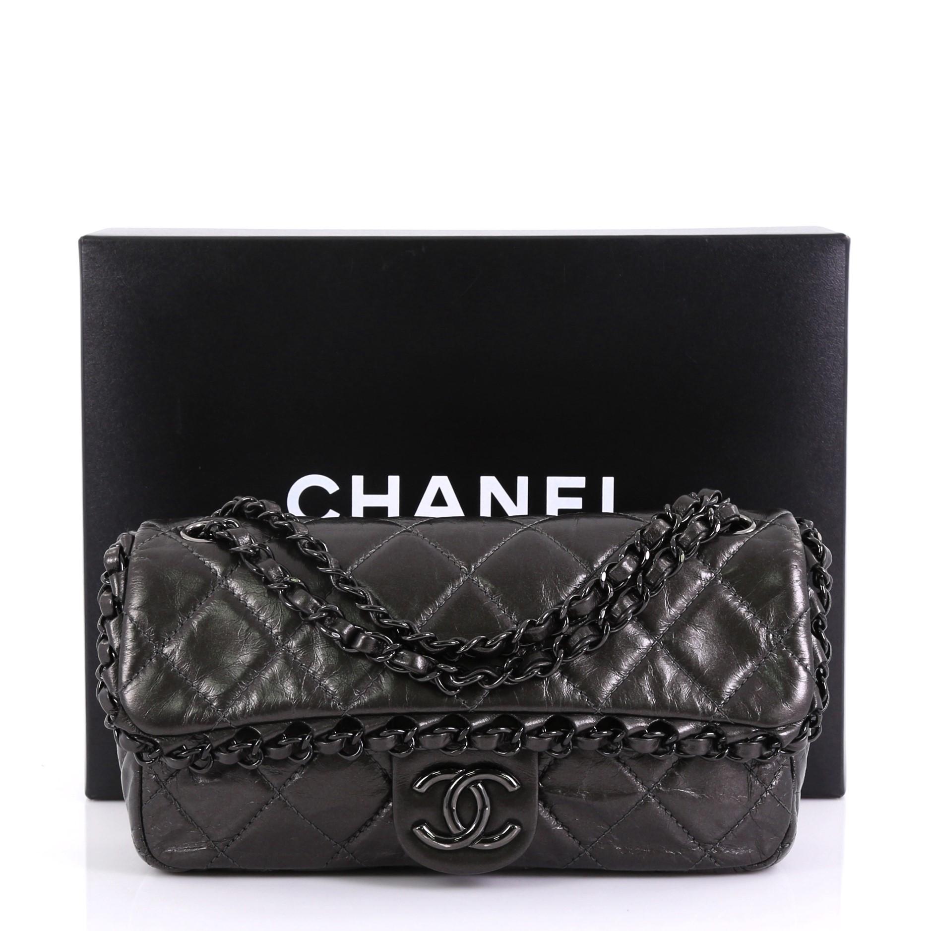 This Chanel Chain Me Flap Bag Quilted Calfskin Medium, crafted from dark gray quilted calfskin leather, features woven-in leather chain strap, chain details around the flap edges, front flap with CC logo and gunmetal and black-tone hardware. Its