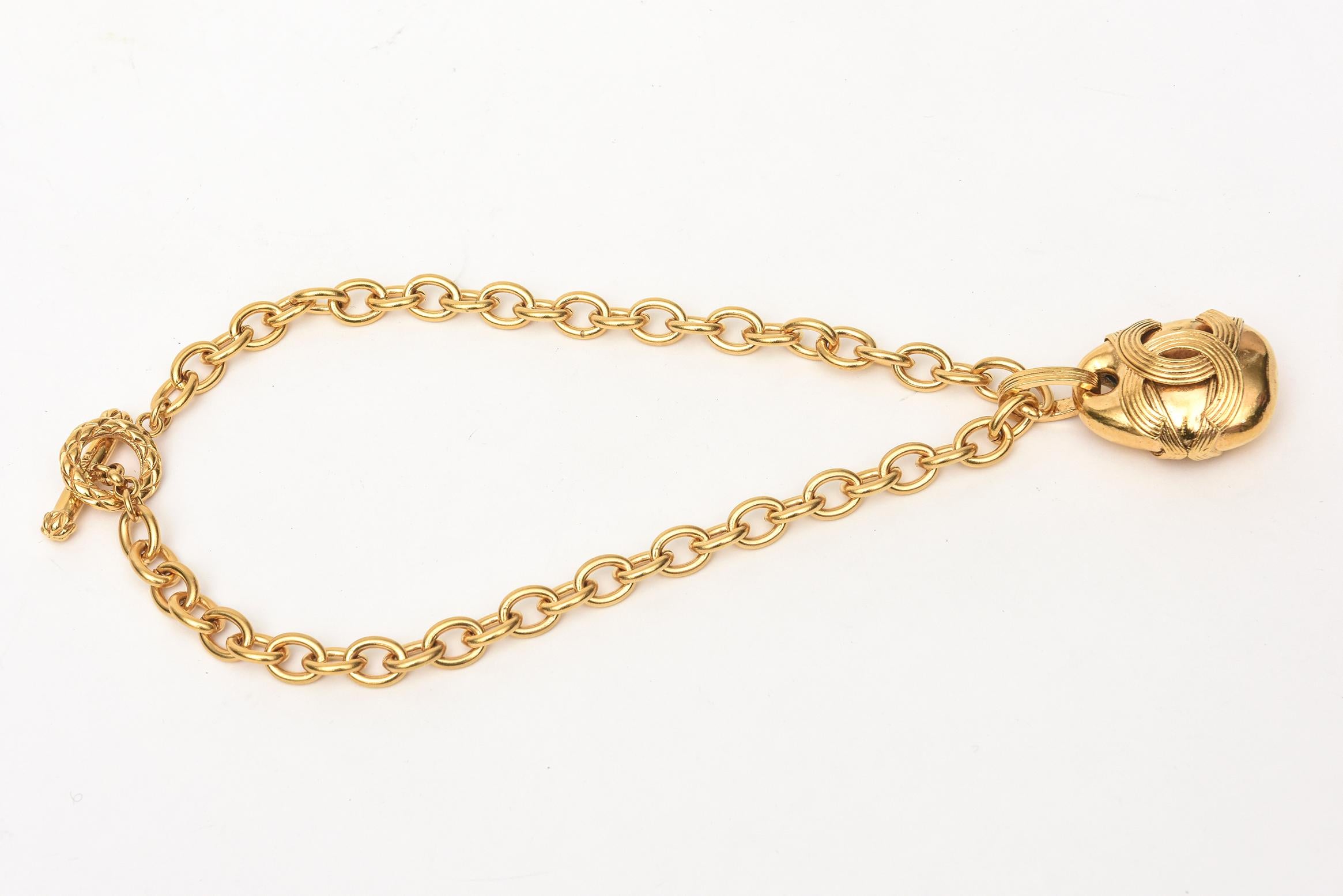 This chunky and fabulous Chanel gold plated chain necklace with large bold hanging CC pendant is marked. It is made in France Autumn of 1994. Chanel is marked on the bar part of the clasp. It is arresting on your neck and looks amazing on. It has