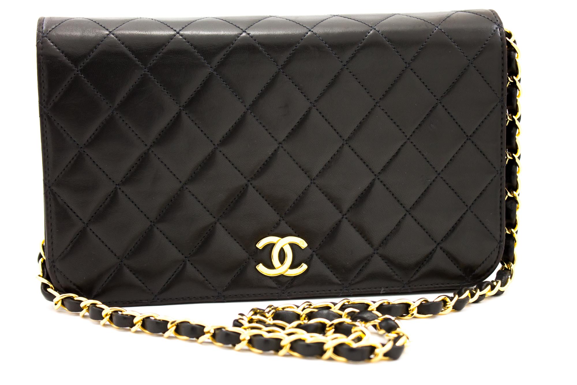 An authentic CHANEL Chain Shoulder Bag Clutch Black Quilted Flap made of black Lambskin. The color is Black. The outside material is Leather. The pattern is Solid. This item is Vintage / Classic. The year of manufacture would be