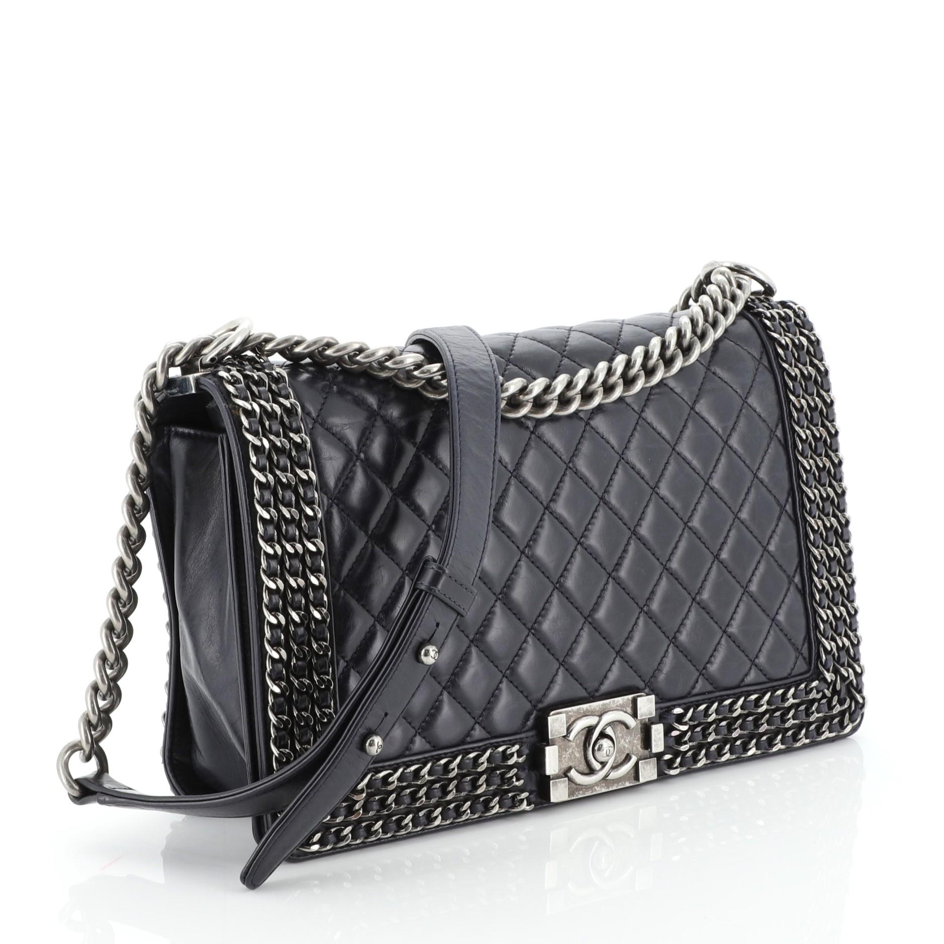 This Chanel Chained Boy Flap Bag Quilted Glazed Calfskin New Medium, crafted in blue quilted glazed calfskin, features chain link trim, chunky chain link strap with shoulder pad, and aged silver-tone hardware. Its CC boy push-lock closure opens to a