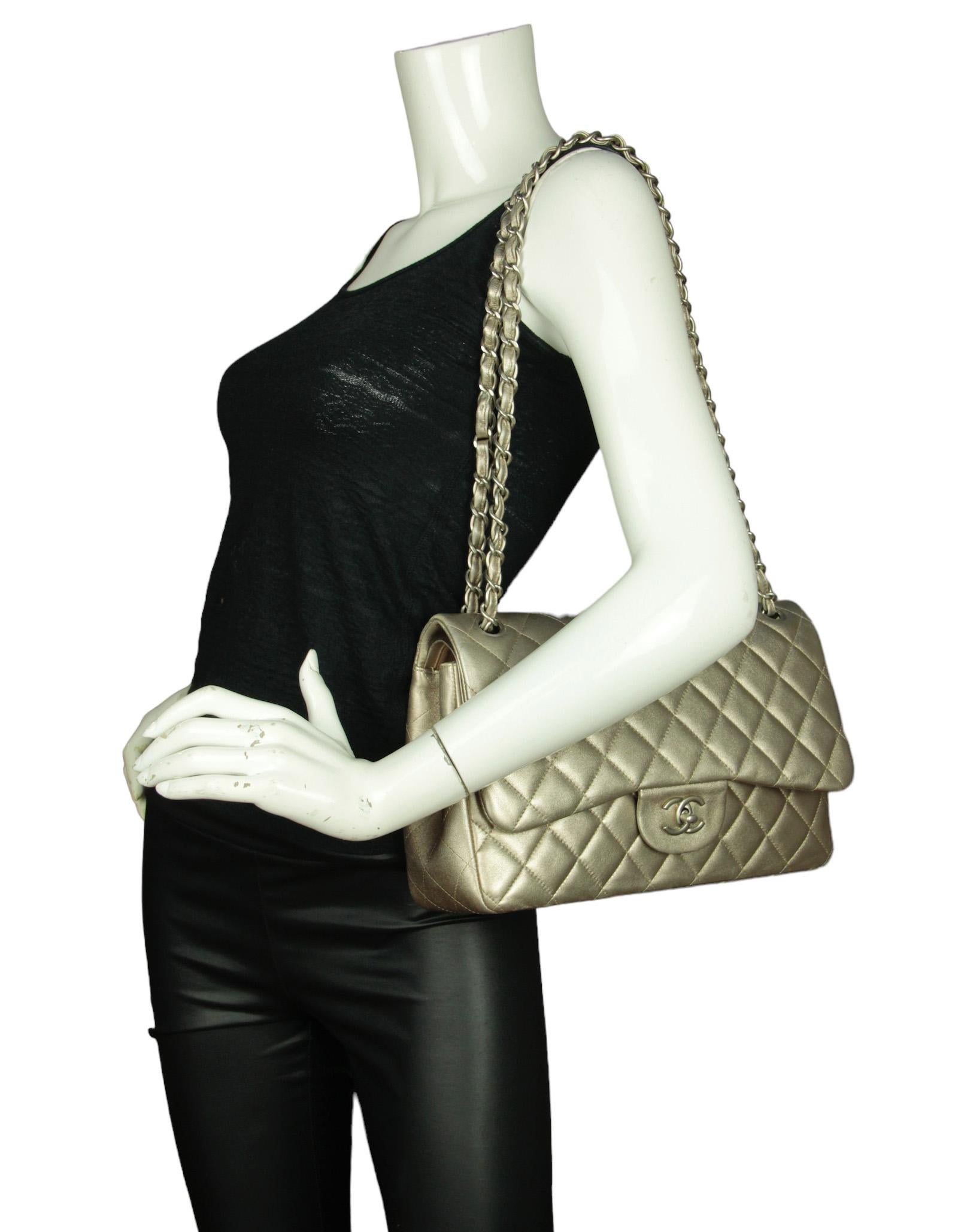 Chanel Champagne Gold Lambskin Leather Quilted Classic Double Flap Jumbo Bag 

Made In: Italy
Year of Production: 2010-2011
Color: Metallic champagne, pale gold
Hardware: Silvertone
Materials: Lambskin leather
Lining: Leather
Closure/Opening: Top