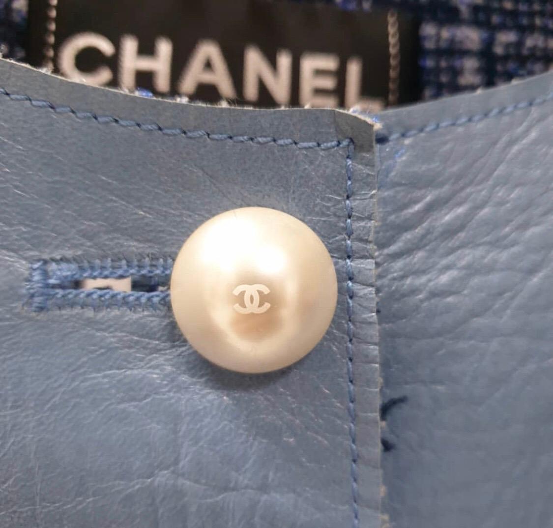 This evening jacket from Chanel in an blue tone is a must have piece in your closet. Crafted out of lambskin leather and lined with soft wool blends, this jacket has a contrast lined design. The pearl buttons further enhance the look of this