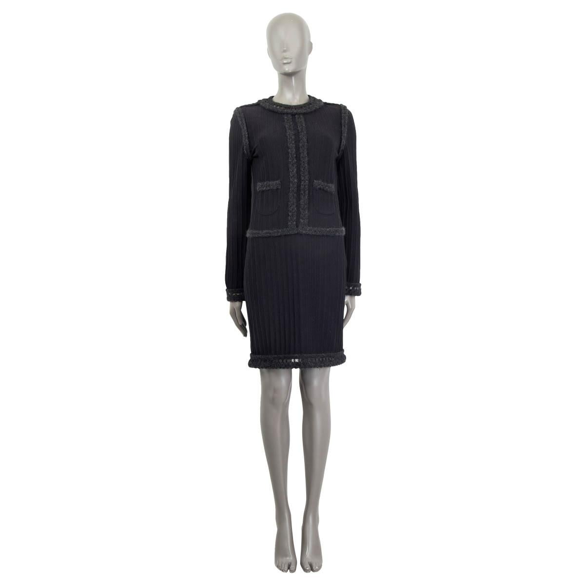 100% authentic Chanel 2010 crochet trim knit dress in black and charcoal wool (61%), nylon (23%) and mohair (16%). Features long sleeves and two patch pockets on the front. Opens with a concealed zipper at the side and two 'CC' buttons at the back.
