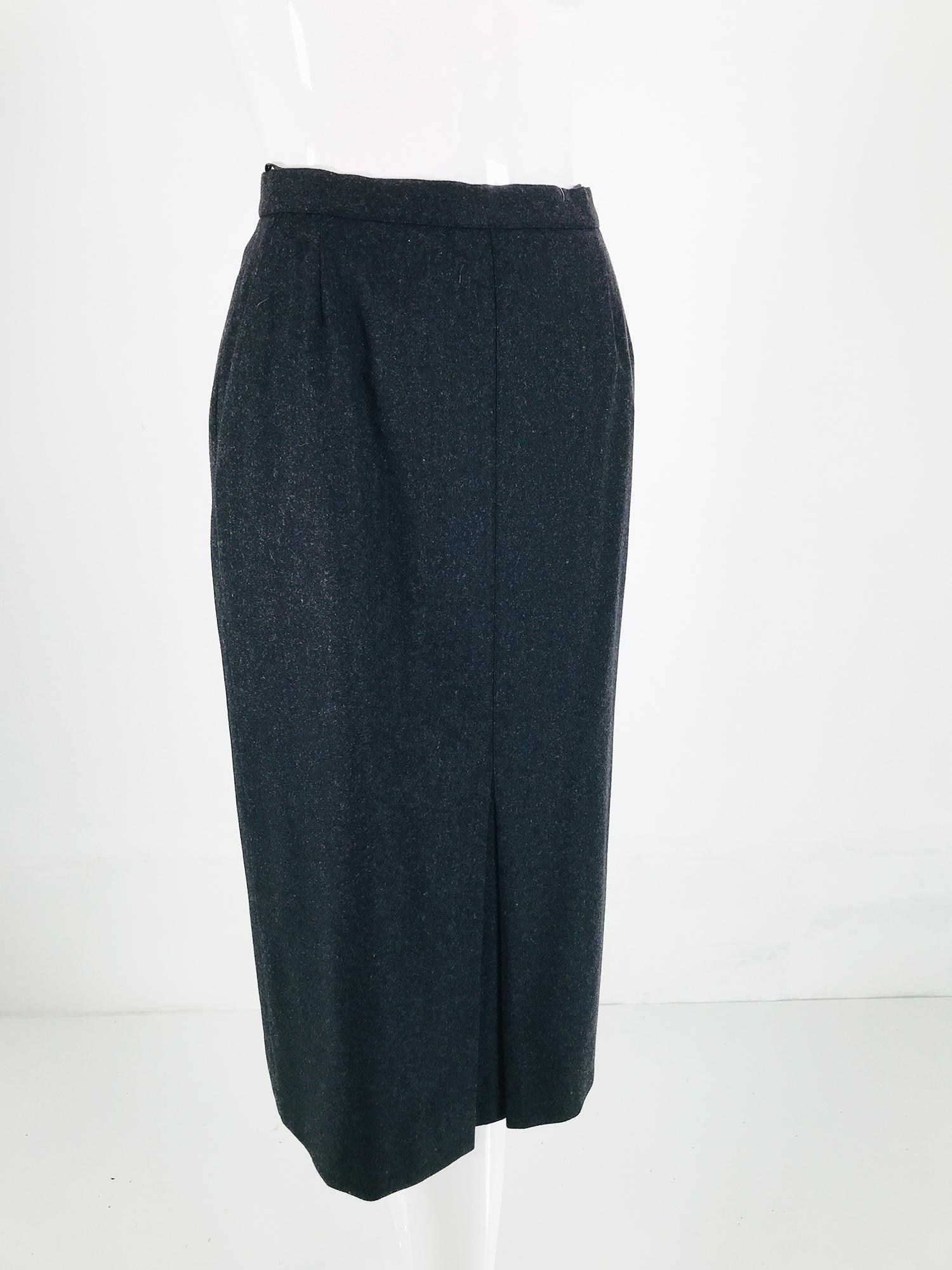 Chanel charcoal wool kick pleat front, curved hip front pocket, pencil skirt. 1990s dark charcoal wool skirt has a narrow band waist, the skirt closes at the side with a bar hook at the waist and a gold Chanel button & button hole, side zipper