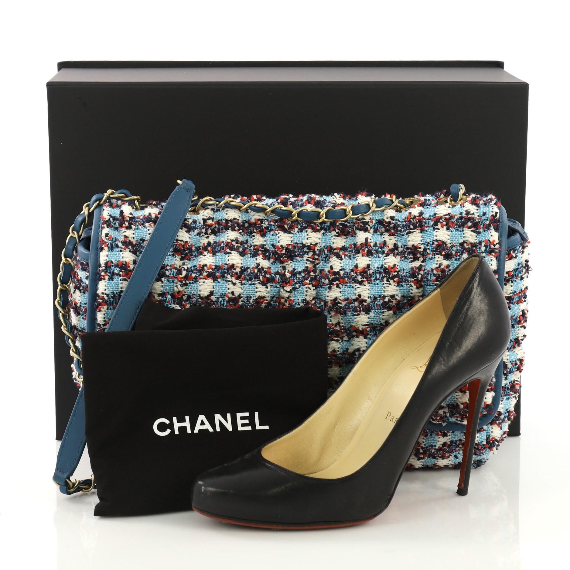This Chanel Chesterfield Flap Bag Tweed Maxi, crafted from blue tweed, features woven-in leather chain strap with leather pad and aged gold-tone hardware. Its CC turn-lock closure opens to a blue nylon interior. Hologram sticker reads: 23836281.