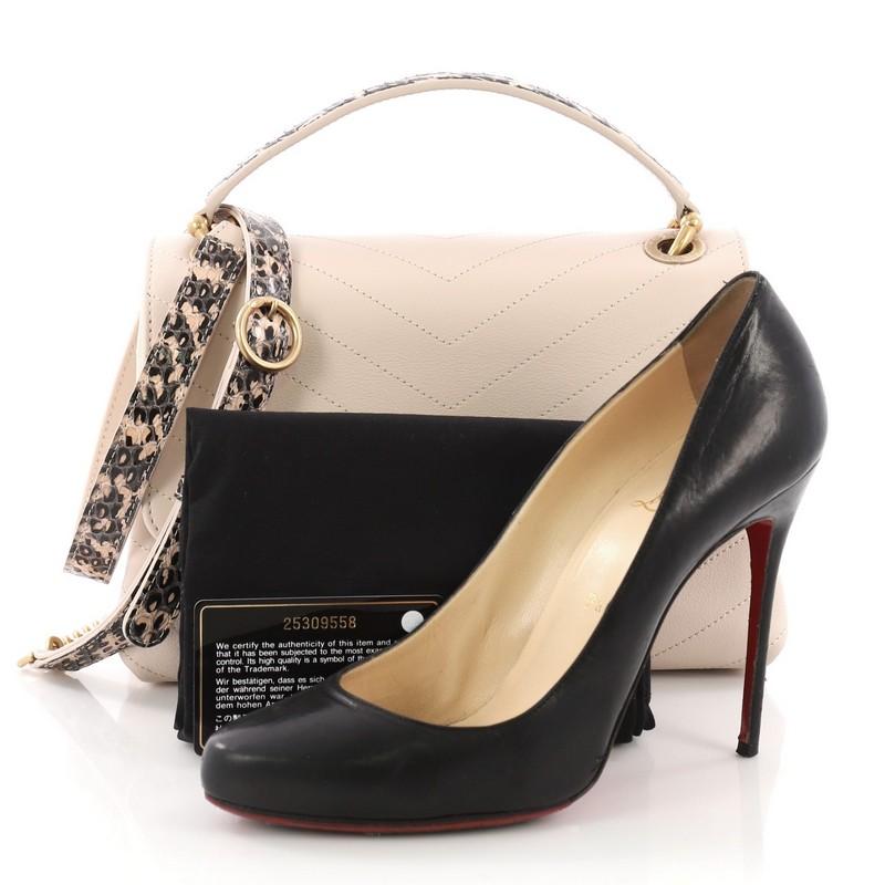 This Chanel Chevron Chic Top Handle Bag Chevron Calfskin with Elaphe Small, crafted from pink chevron calfskin with elaphe, features flat top handle, adjustable strap with chains, and gold-tone hardware. Its CC turn-lock closure opens to a pink