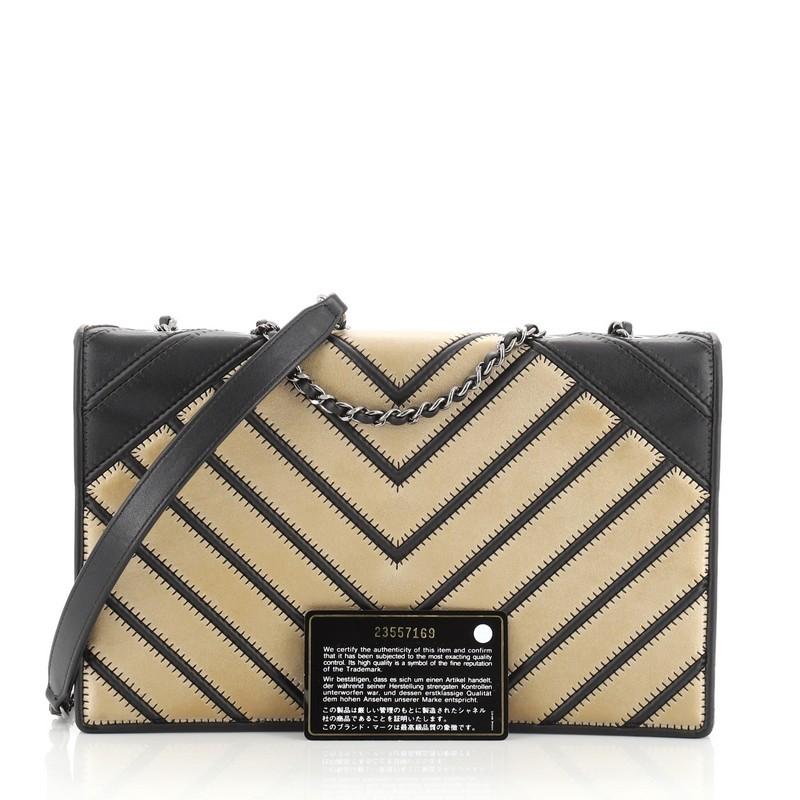 This Chanel Chevron Couture Flap Bag Stitched Chevron Lambskin Medium, crafted in black and gold leather, features woven-in leather chain strap with leather pad, black fabric side panels and gunmetal-tone hardware. Its turn-lock closure opens to a
