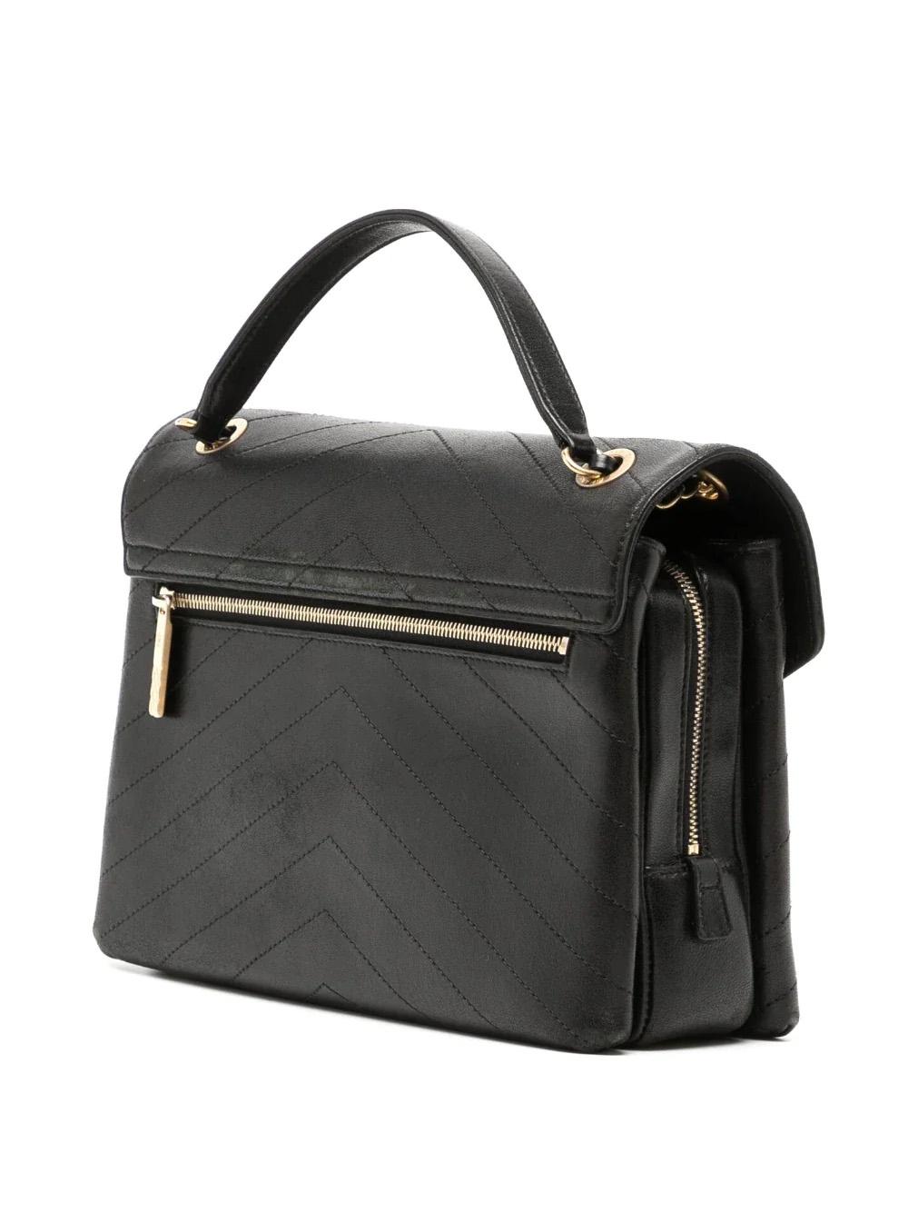 This black leather Chevron Flap Bag has a signature chevron quilting, leather and chain-link shoulder strap, front flap closure, signature interlocking CC turn-lock fastening, and gold-tone hardware. It also boasts a zip-fastening compartment,
