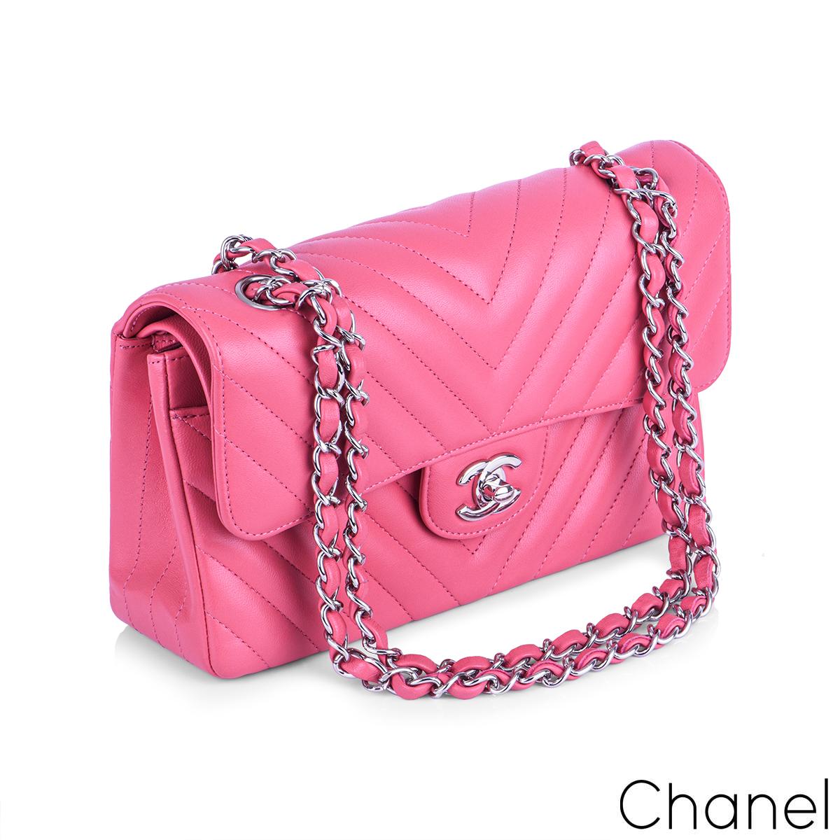 
A Chic Chanel Chevron Double Flap Handbag. The exterior of this small classic is in pink lambskin leather with silver tone hardware. This small flap has the signature chevron style stitching. It features a front flap with signature CC turnlock