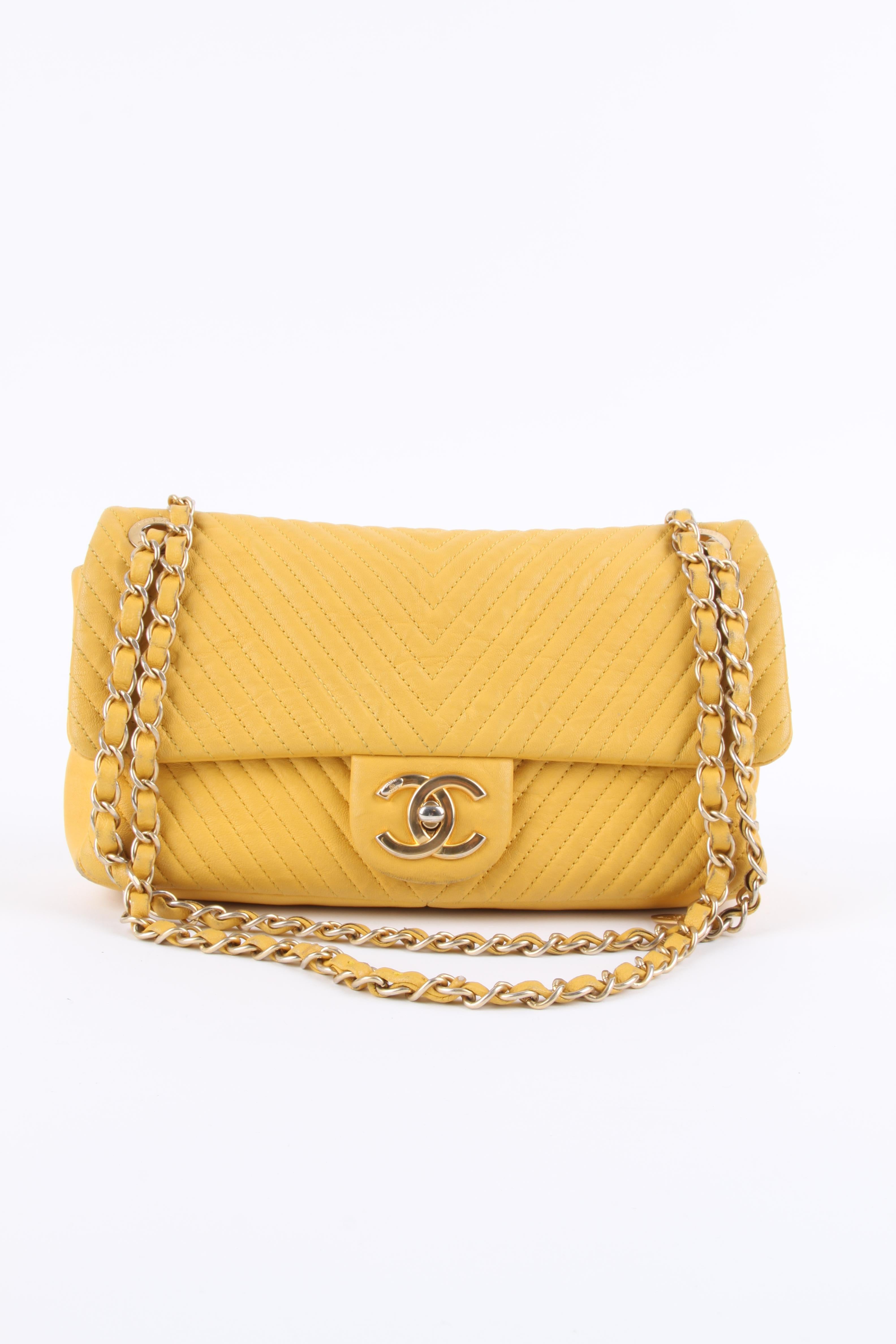 The Chanel Chevron Quilted Rectangular Flap Bag in ocher yellow leather. Woww!! 

The exterior quilting is vertically applied, Chanel named this pattern Chevron. Closure at the front with a gold-tone CC turnlock, the long chain is entwined with