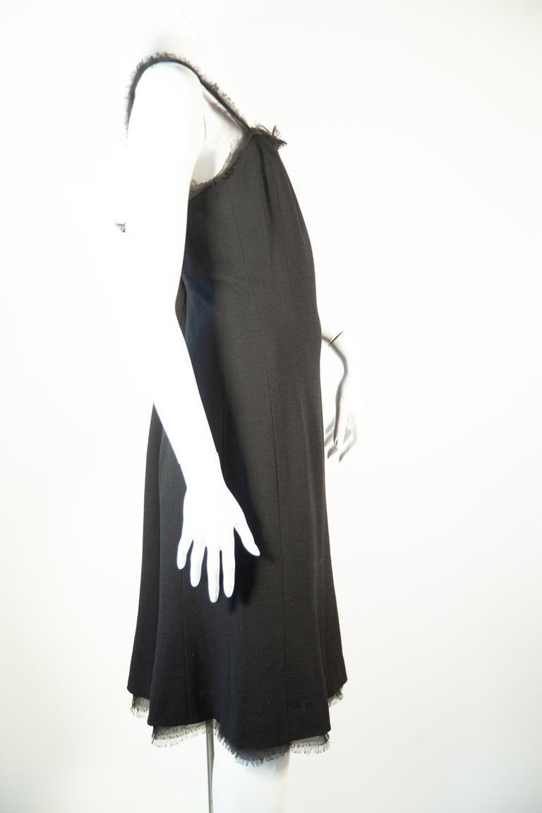 From the late 1990's - Early 2000's collection by Karl Lagerfeld 

Chanel black light wool strappy dress with fringe straps and fringe flounce skirt hem detail. 

Sz 42 / US 10
