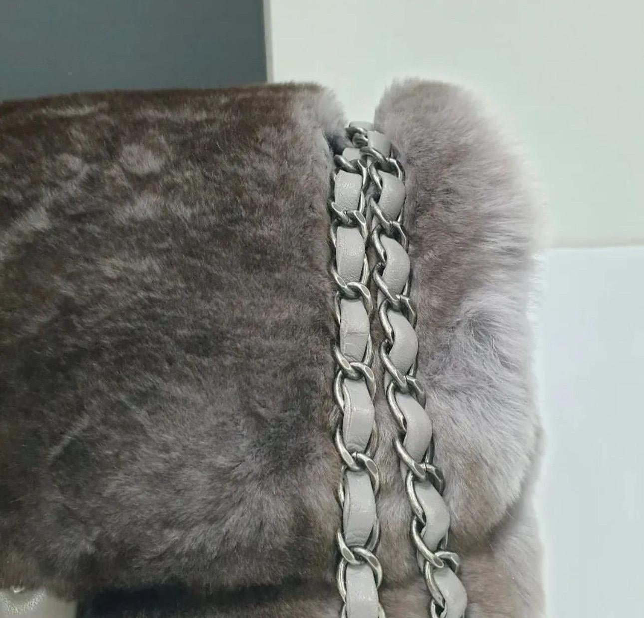 Natural chinchilla Chanel Flap bag with ruthenium hardware, single convertible chain-link and leather shoulder strap, grey interior and zip-closure at top with additional CC turn-lock closure at front flap. 
Very good condition. No box. No dust