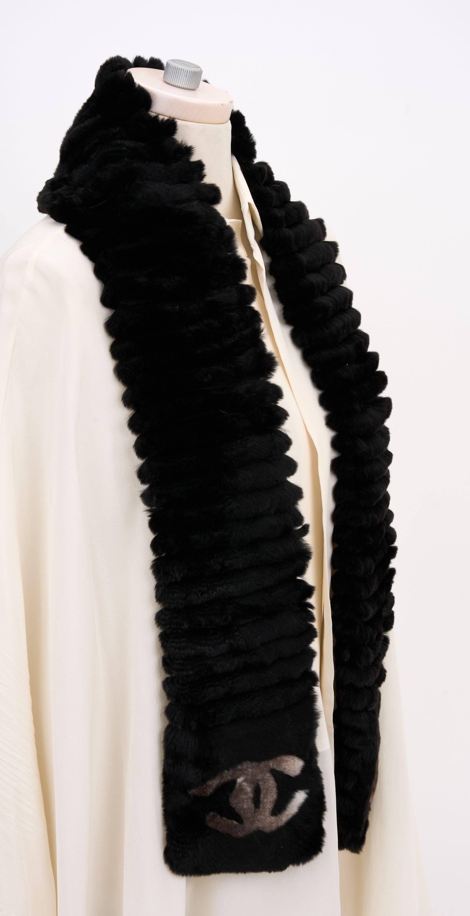 This Chanel Cincilla Orylag CC Scarf in Black and Grey CC, features a very elegant and classic look crafted of 70% luxurious Orylag rabbit fur and 30% cashmere in black. The ends feature a Chanel CC logo. Brand new in unused condition.
