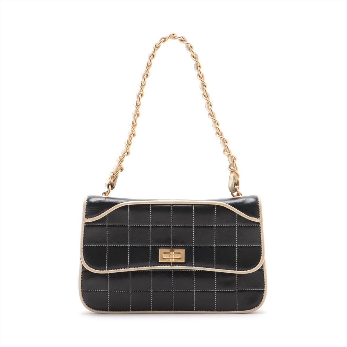 The Chanel Chocolate Bar Lambskin Chain Shoulder Bag Black x Ivory is a unique and sophisticated accessory that combines modern design with timeless luxury. Crafted from soft lambskin leather, its distinctive quilted pattern, reminiscent of