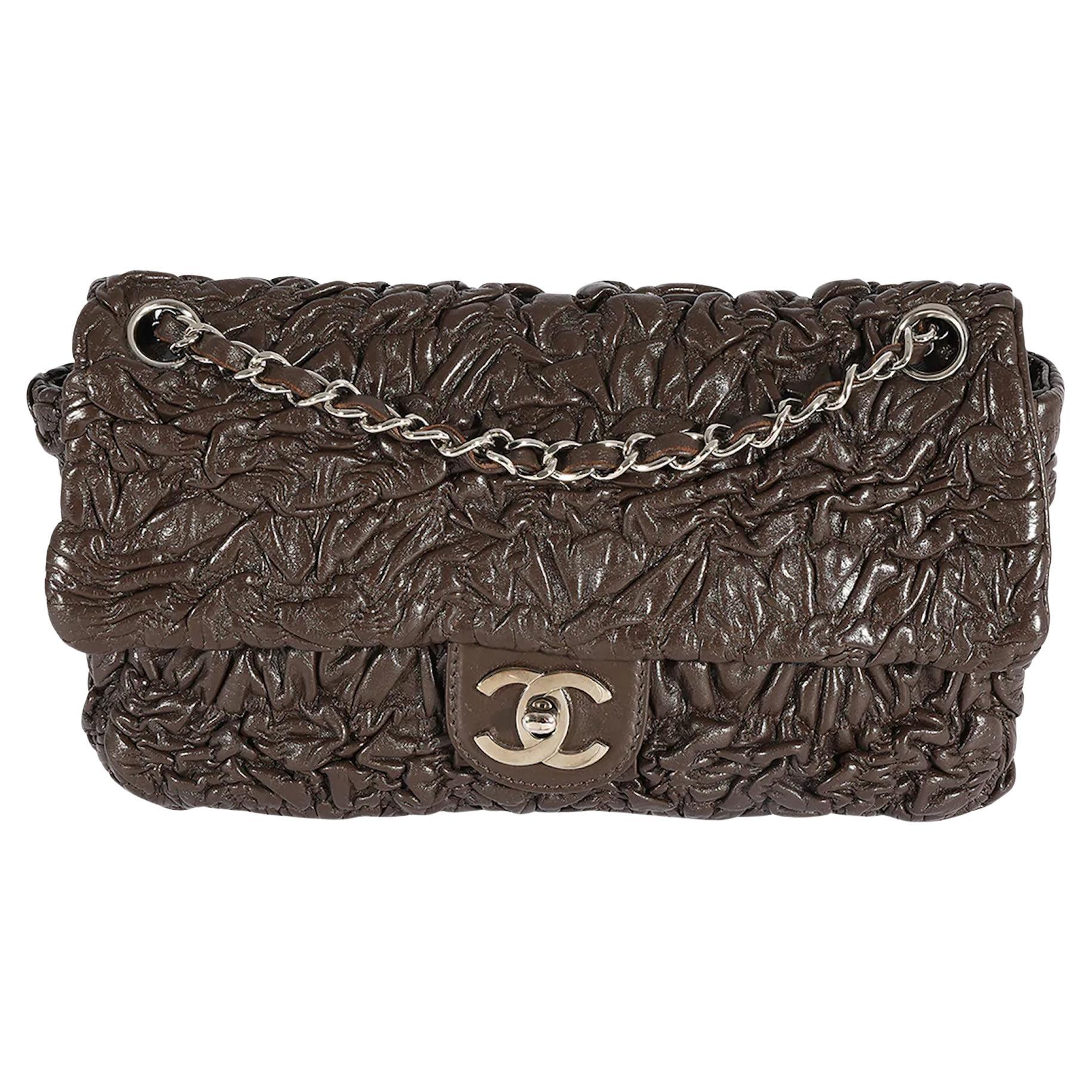 Chanel Chocolate Brown Ruched Wrinkled Leather Medium Classic Flap Bag 

Fall 2007 

Silver hardware
Classic interwoven leather shoulder strap
Brown ruched wrinkled leather 
Silver CC turn-lock closure 
Black nylon lining
Single interior zippered