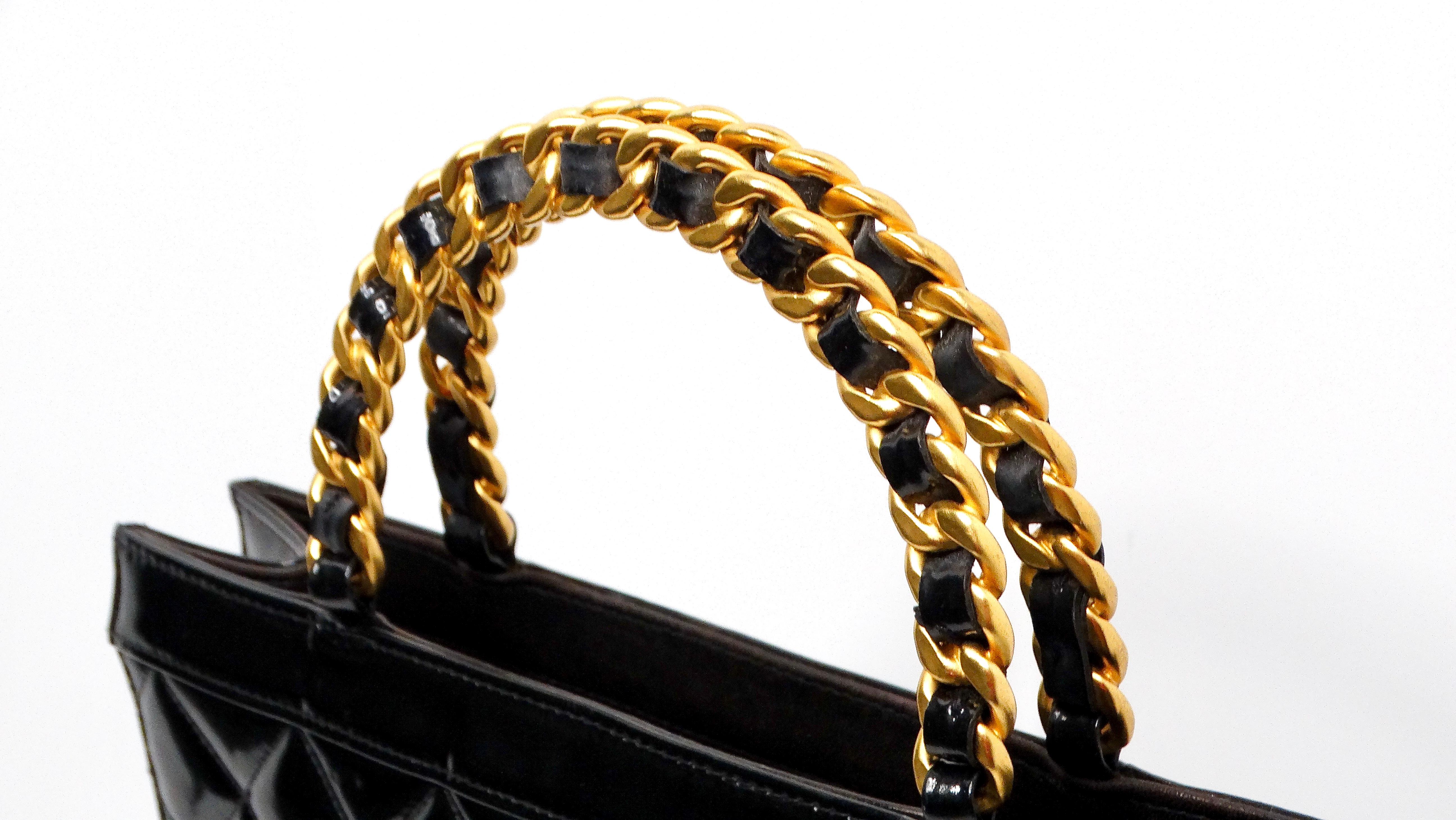 
The Circa 1990s Chanel Black Quilted Patent Leather Vintage Tote is an exquisite piece that combines timeless elegance with practical functionality. Tall and thin in design, this tote can accommodate all your essentials and more, making it an