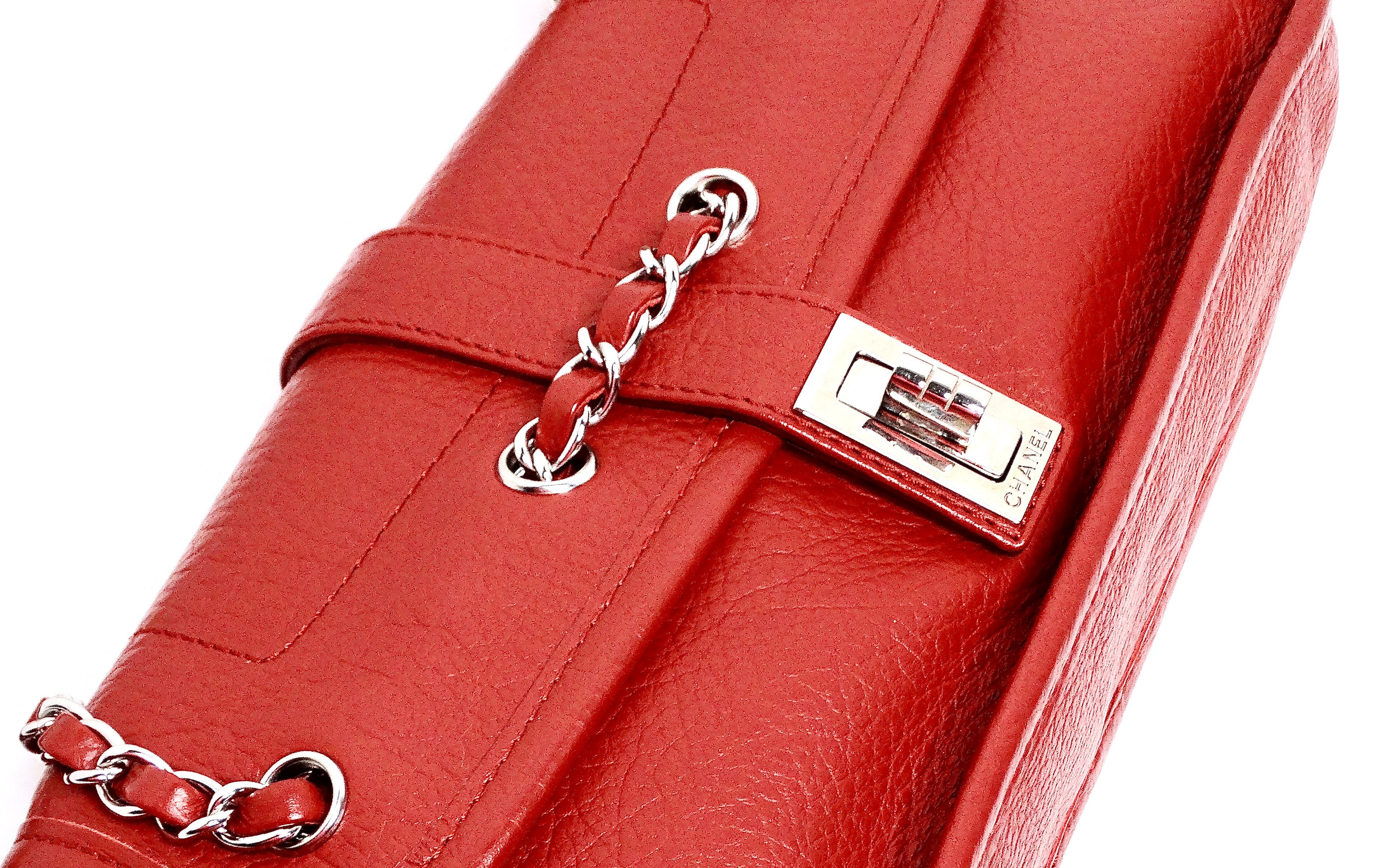 The Y2K Chanel Mademoiselle Lock Red Leather Shoulder Bag, dating back to the early 2000s (circa 2003-2004), is a captivating piece that embodies the era's chic and playful fashion. Featuring silver hardware and a classic leather chain strap, this