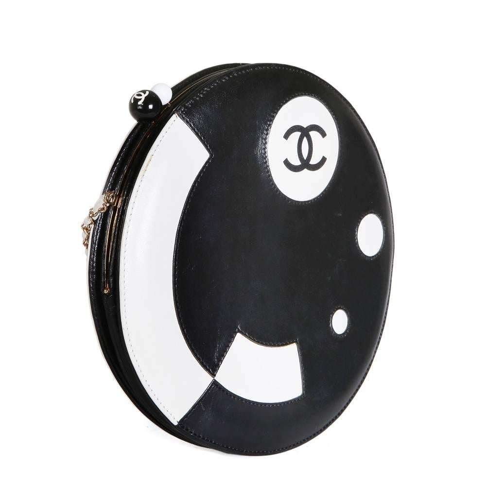 Bag by Chanel circa 2003
Black and white leather with gold hardware
Structured and slim design
Chain strap that can be tucked into bag
White leather lining
8.75