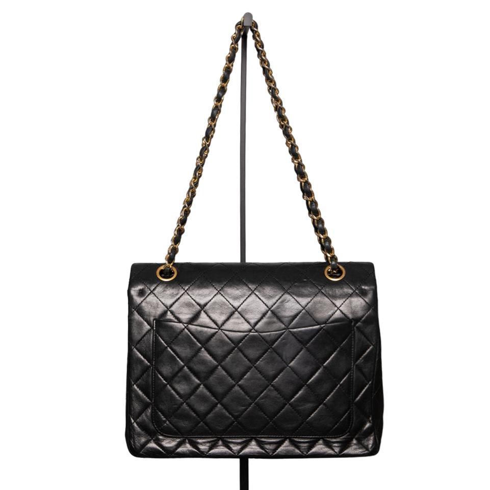 The Chanel Classic Double Flap Bag is a true masterpiece of craftsmanship and a symbol of the timeless luxury of the Chanel brand. This bag, made from first-class calfskin in a deep black shade, is a real eye-catcher. Measuring 25x19x7.5 cm, it