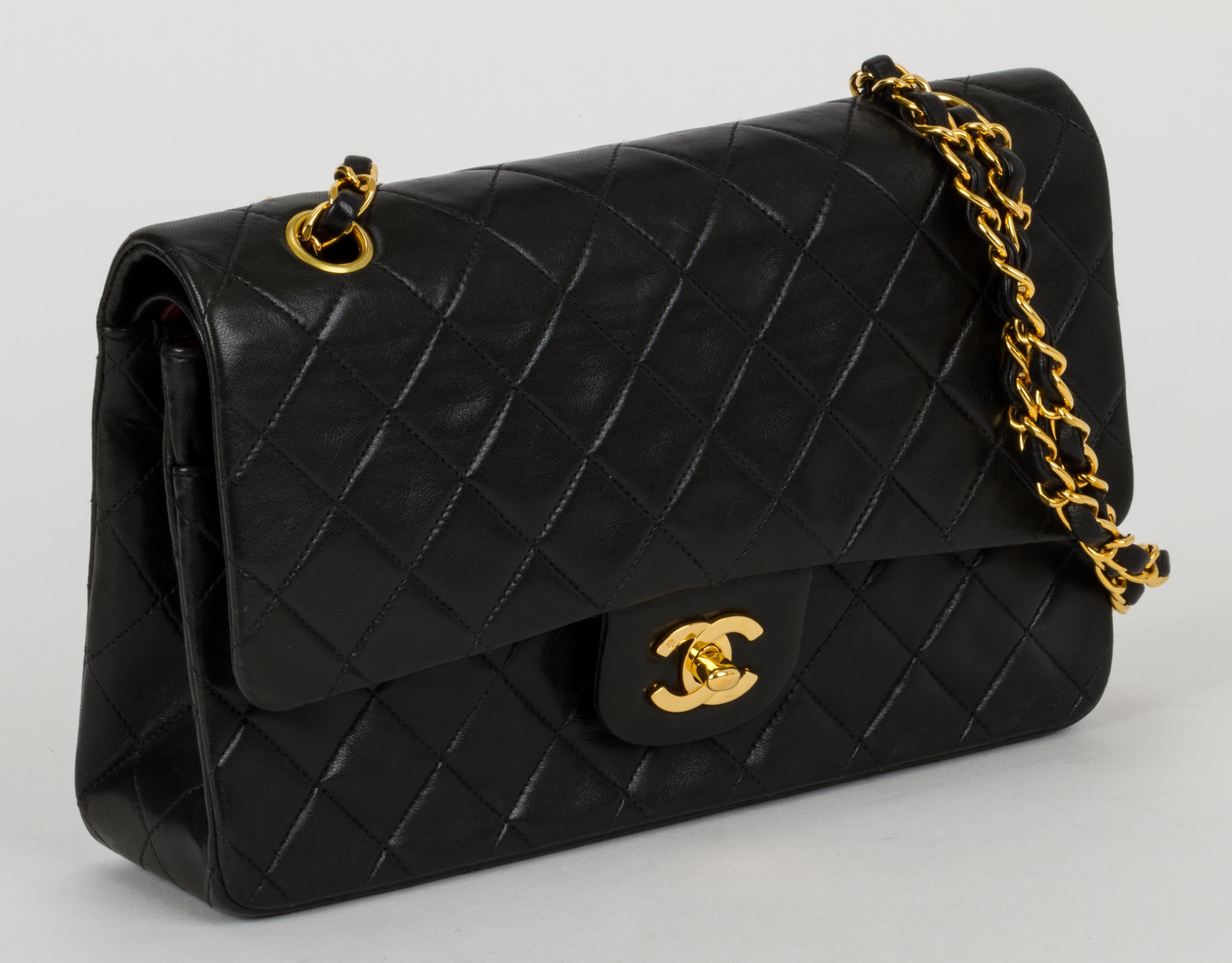 Chanel black classic double flap lambskin 2.55 bag. Can be worn two ways: shoulder drop, 17.5