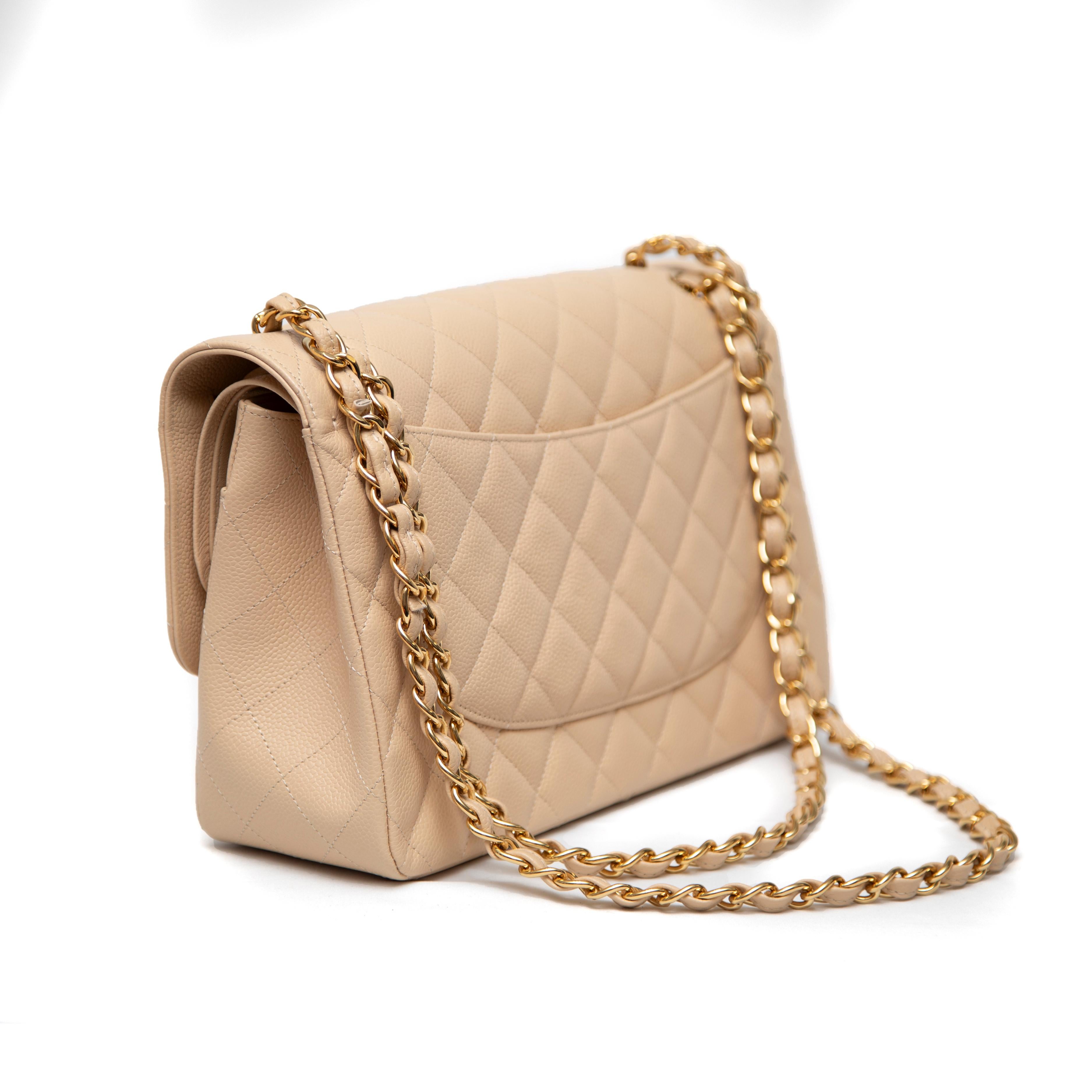 Elegant and timeless, this Chanel Classic Double Flap Bag from 2006/2007 is crafted from luxurious beige caviar leather, known for its durability and textured finish. The soft beige hue offers a versatile, neutral tone, making it perfect for both