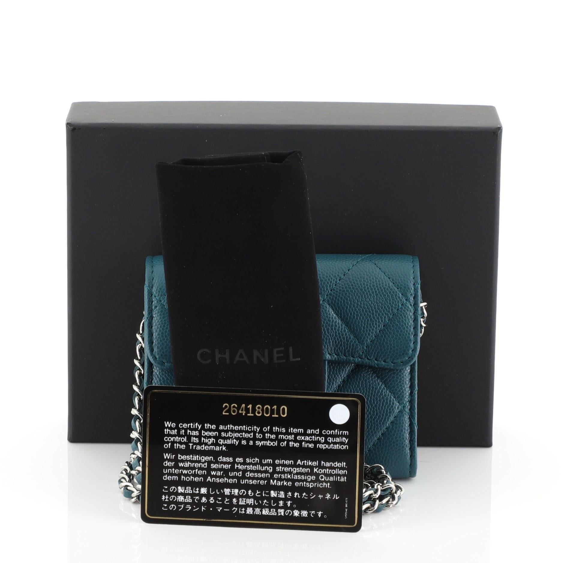 This Chanel Classic Clutch with Chain Quilted Caviar Mini, crafted from green quilted caviar leather, features woven-in leather chain strap and silver-tone hardware. Its snap closure opens to a green fabric interior. Hologram sticker reads: