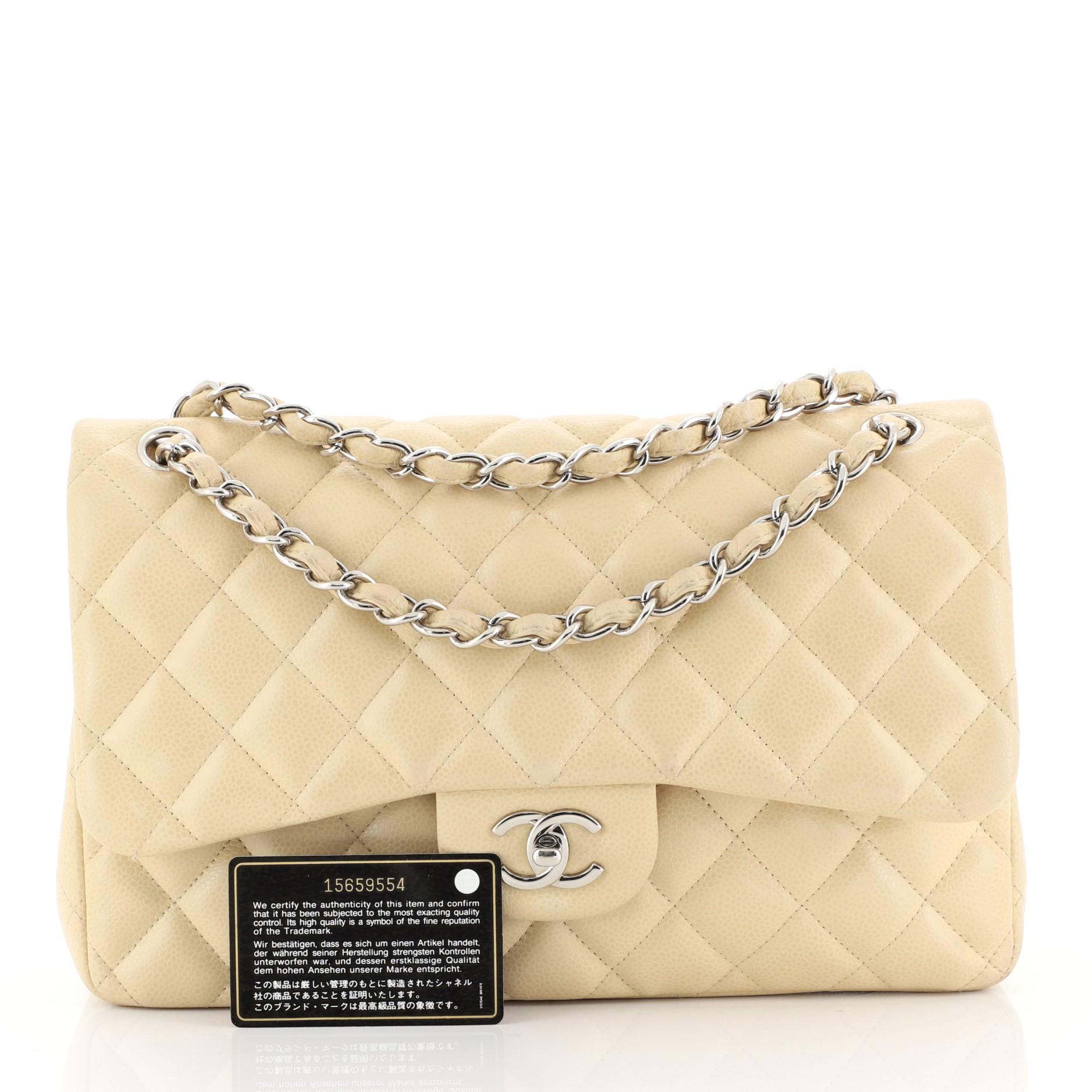 This Chanel Classic Double Flap Bag Quilted Caviar Jumbo, crafted from neutral quilted caviar leather, features woven-in leather chain strap, exterior back pocket and silver-tone hardware. Its double flap and frontal CC turn-lock closure opens to a